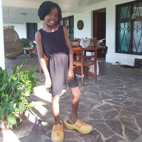 local Mozambican girl Vilanculos with wooden shoes