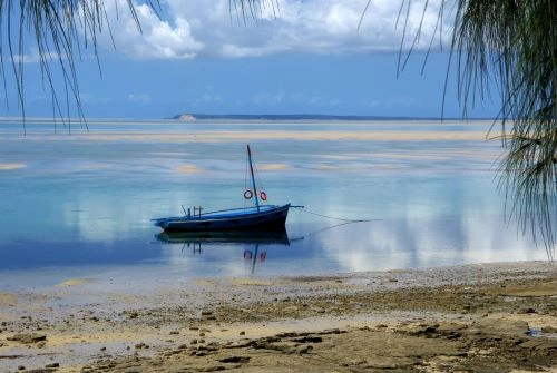 Traditional dhow floating in the calm, turquoise waters near Vilanculos, Mozambique – a serene glimpse of local coastal life  (credit Mozambique Horse Safari)