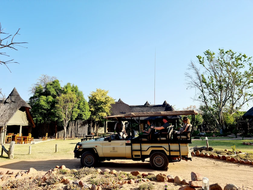 Family enjoying a safari game drive in southern Africa bushveld.